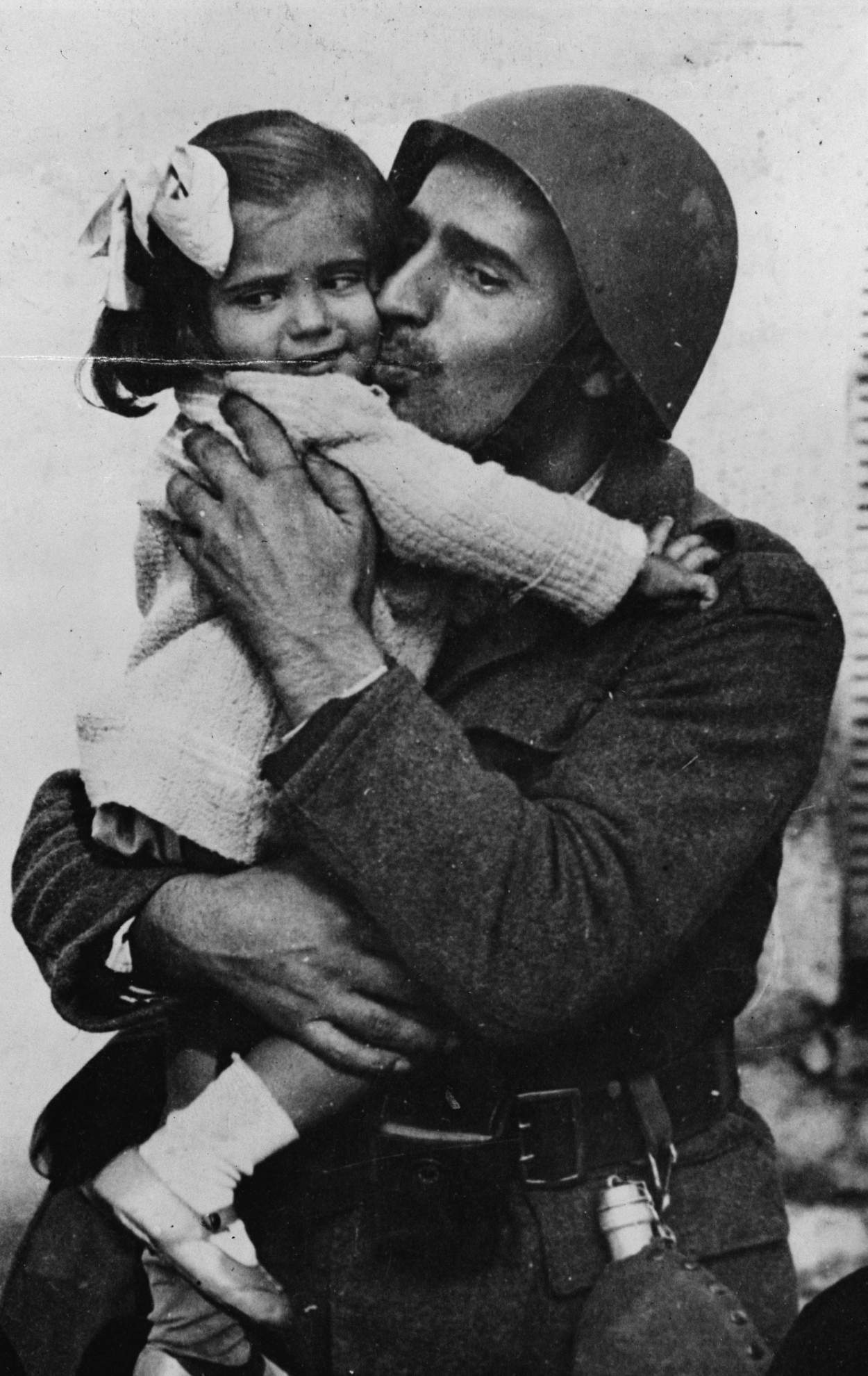 a-greek-soldier-holding-his-little-daughter-in-his-arms