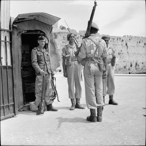 Men of the Bhopal Regiment take over a sentry position from a German soldier following the arrival of the first British and Indian forces on Rhodes after the signing of the unconditional surrender of German forces.