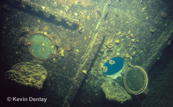 A porthole hangs open inside the wreck of Hr. Ms. Java