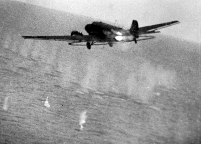 Still from camera-gun footage shot from a RAF Hawker Typhoon Mark IB flown by Flying Officer W.V. Mollett of No. 266 Squadron RAF, showing the shooting down of a Junkers Ju 52/3mg6e minesweeping aircraft of the Minensuchgruppe off Lorient, France. Cannon shells from Mollett's aircraft are striking the sea and the fuselage of the Ju 52, which crashed into the sea shortly afterwards. Mollet shared the destruction of the Ju 52 with Flying Officer N.J. Lucas, also of 266 Squadron. Source: IWM